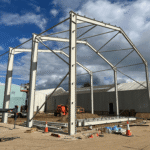 Beams and rafters erected to form a steel frame for a building