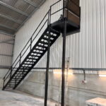 Internal steel staircase in an agricultural building