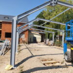 Structural steel beams and colums forming the frame for an extension on a tradional brick built building