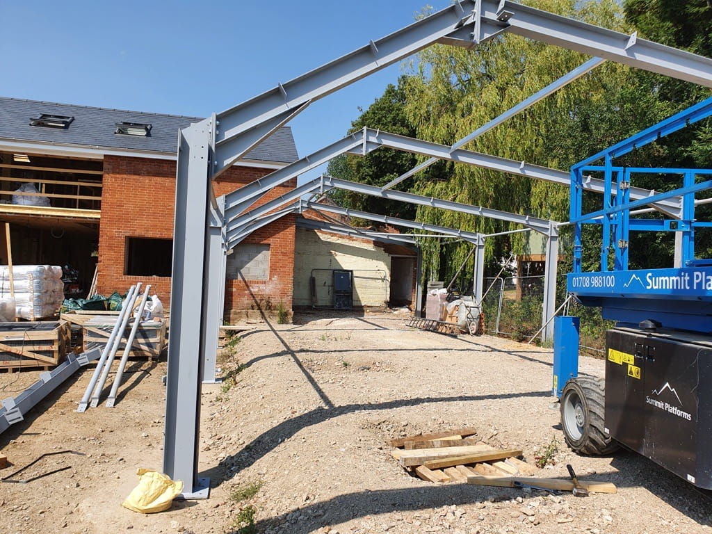 Structural steel beams and colums forming the frame for an extension on a tradional brick built building