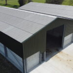 Steel frame twin apex grainstore with two roller shutter doors to the gable end